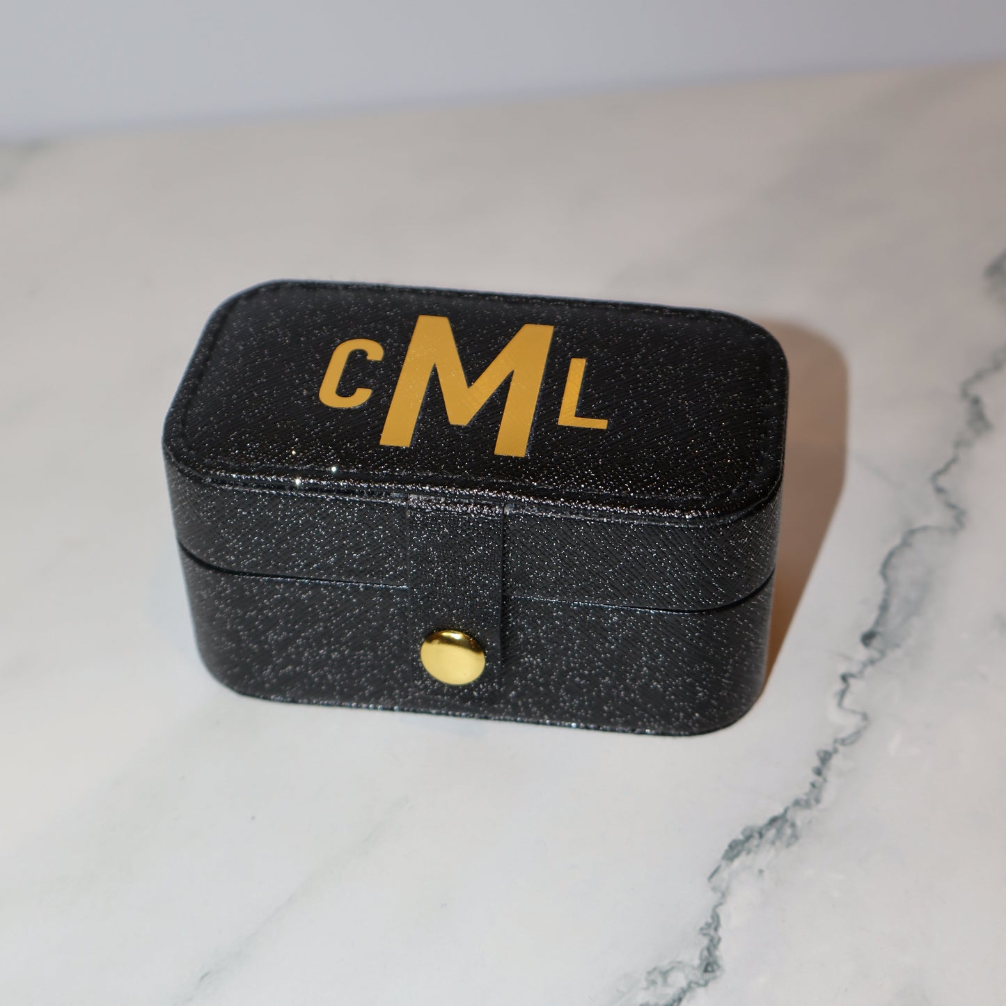 Black case with 'CML' branding on a marble surface