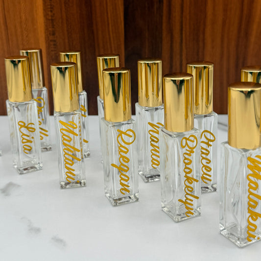 Row of clear hair extensions with gold names on a marble surface