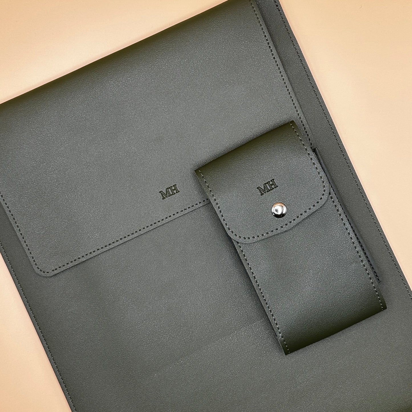 “Green personalized PU leather laptop sleeve with debossed initials and matching accessories.”