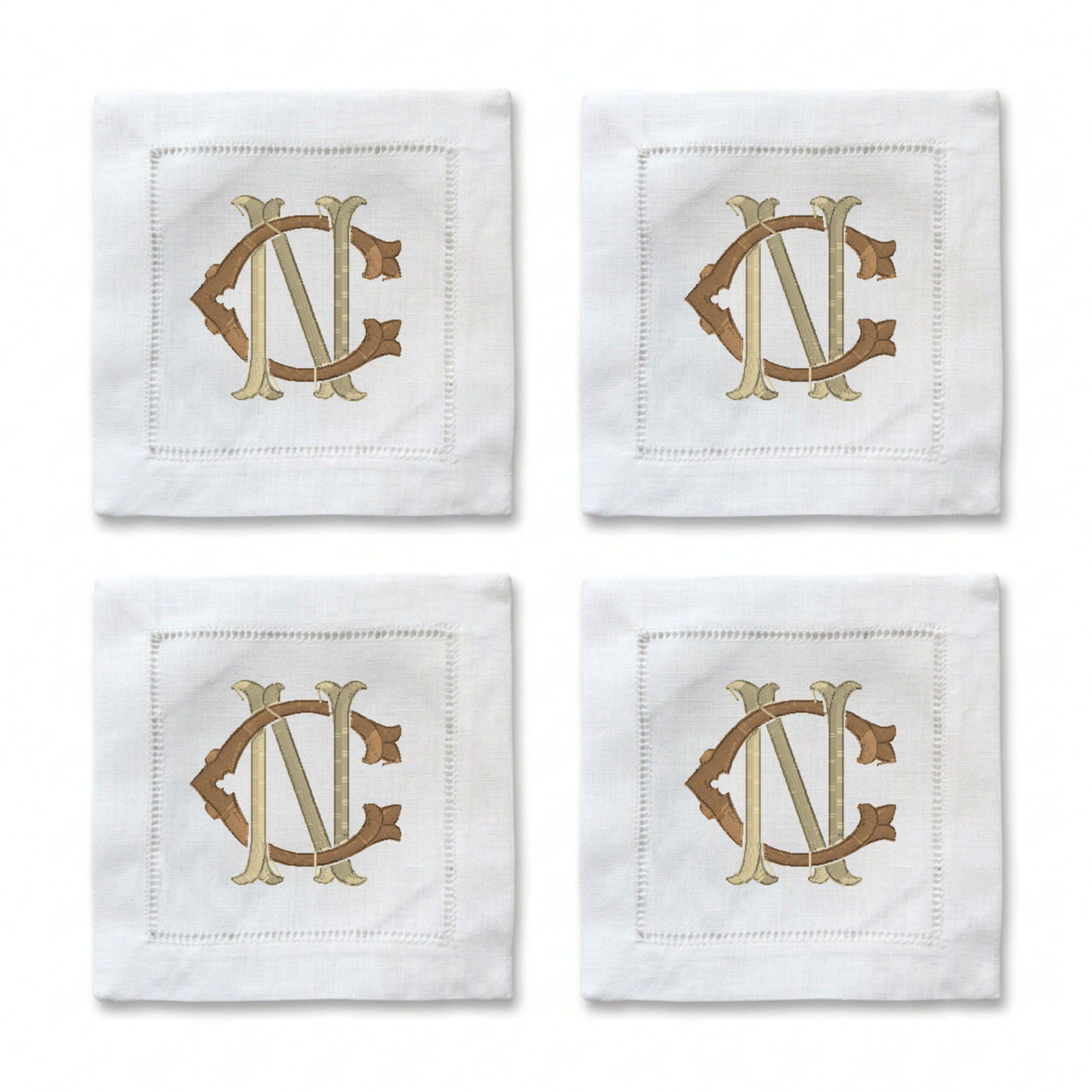 Four white square napkins arranged in a 2x2 grid, each featuring an embroidered monogram design in beige and brown.