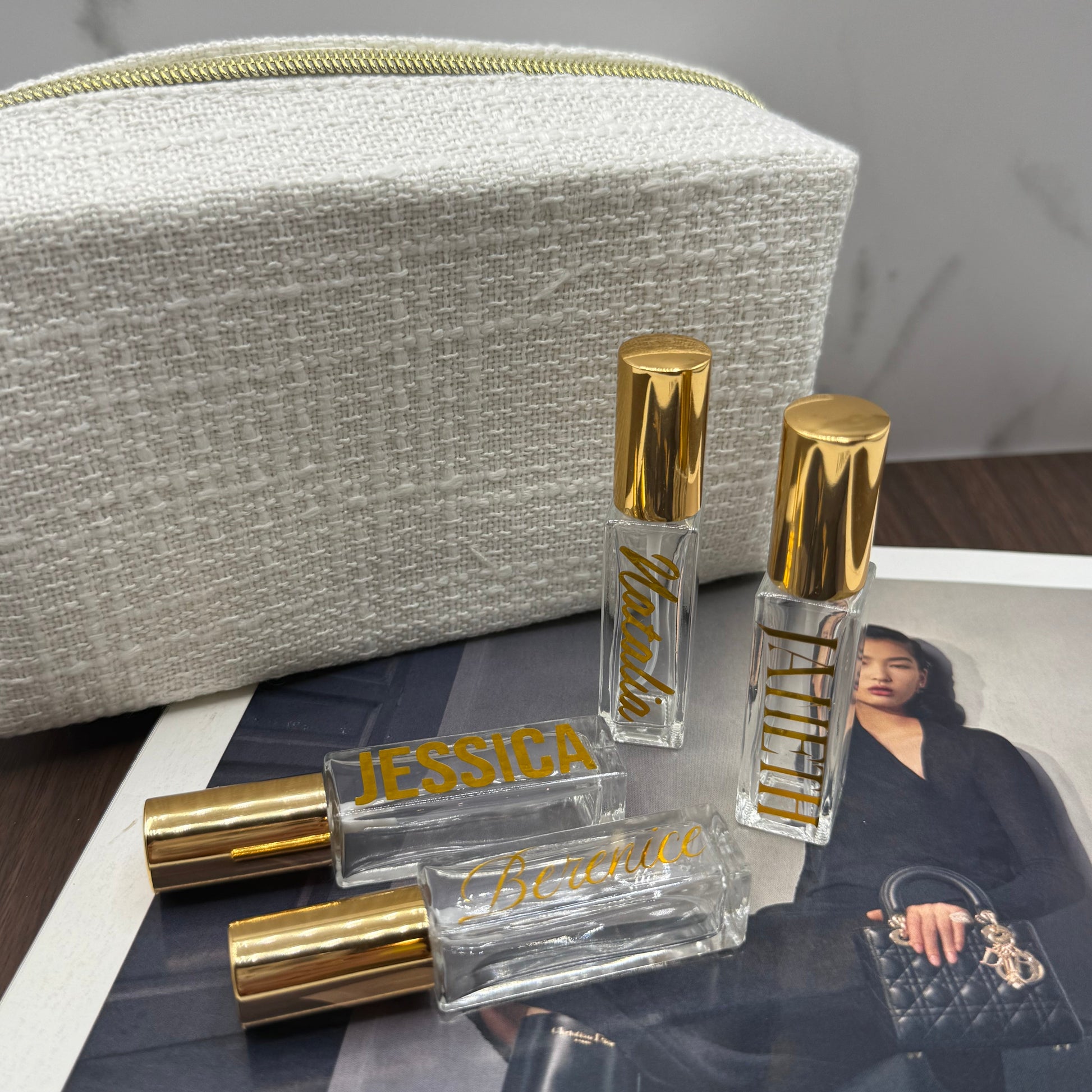 Small perfume bottles with gold caps on a magazine